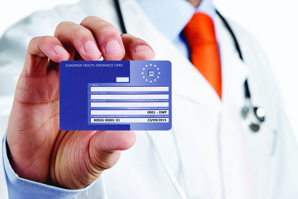 A doctor holding European Health Insurance Card