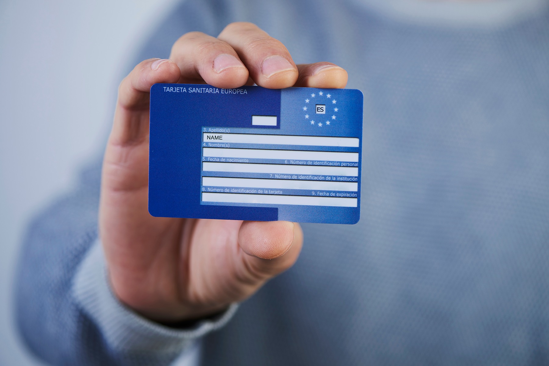 A man holding an European Health Insurance Card France
