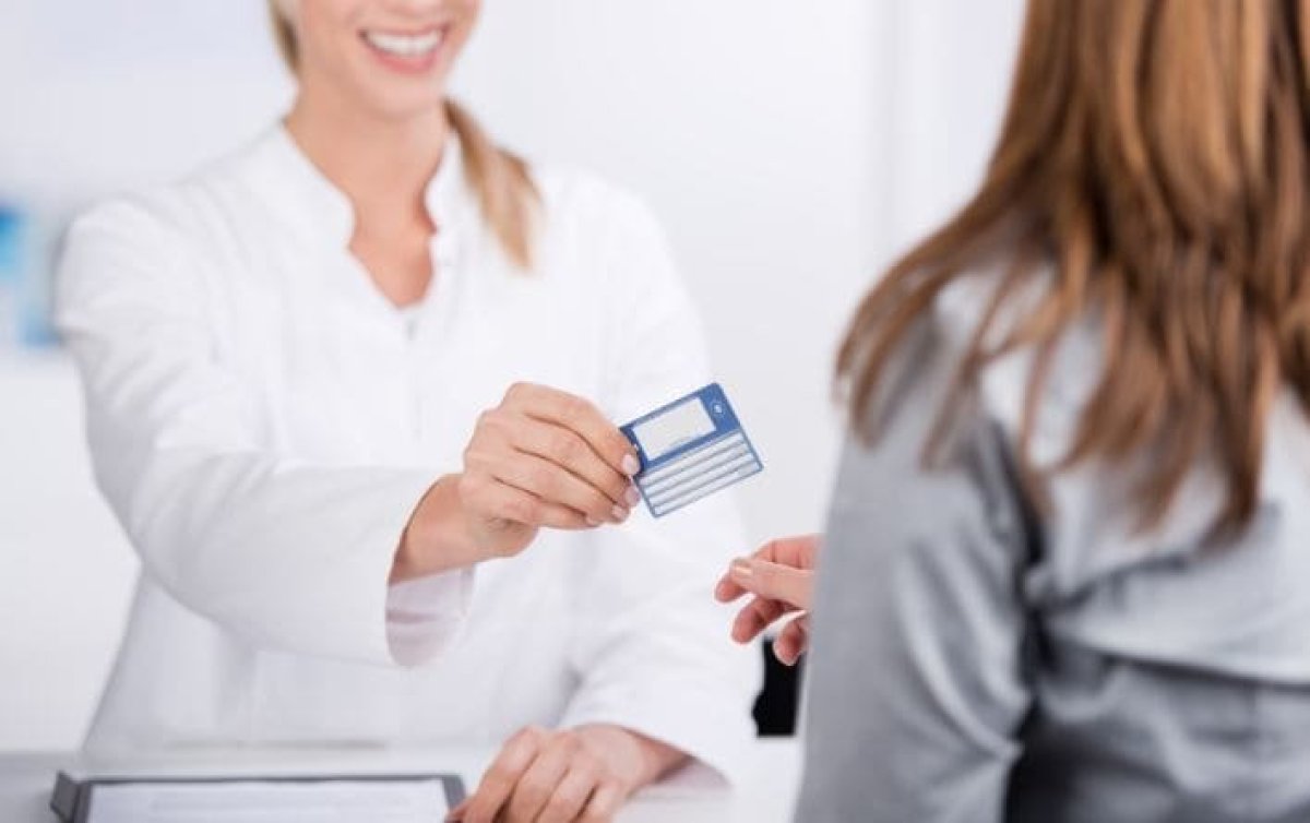 A woman handing the European Health Insurance Card to a woman