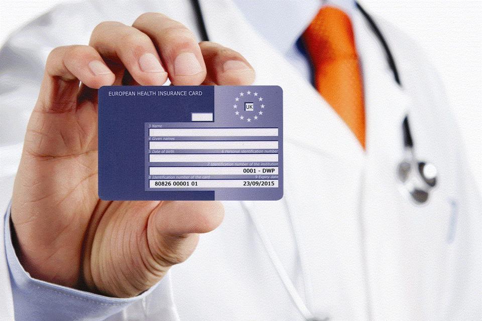 A doctor holding a European Health Insurance Card