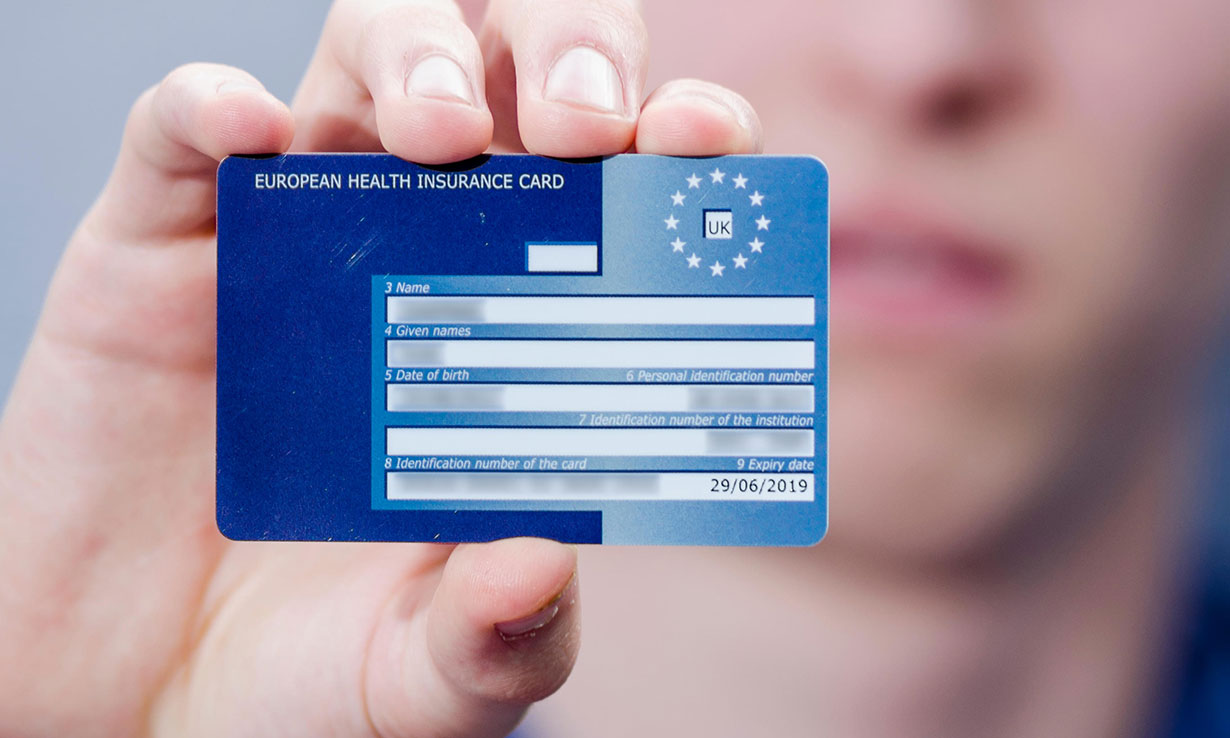 A person holding a European Health Insurance Card